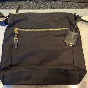 Tumi crossbody or shoulder bag. Black nylon with gold embellishments.
